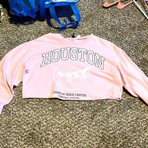 I am selling a pink cropped Houston nasa long sleeve shirts